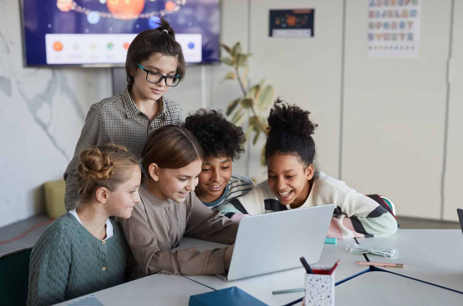 Group of students around a laptop