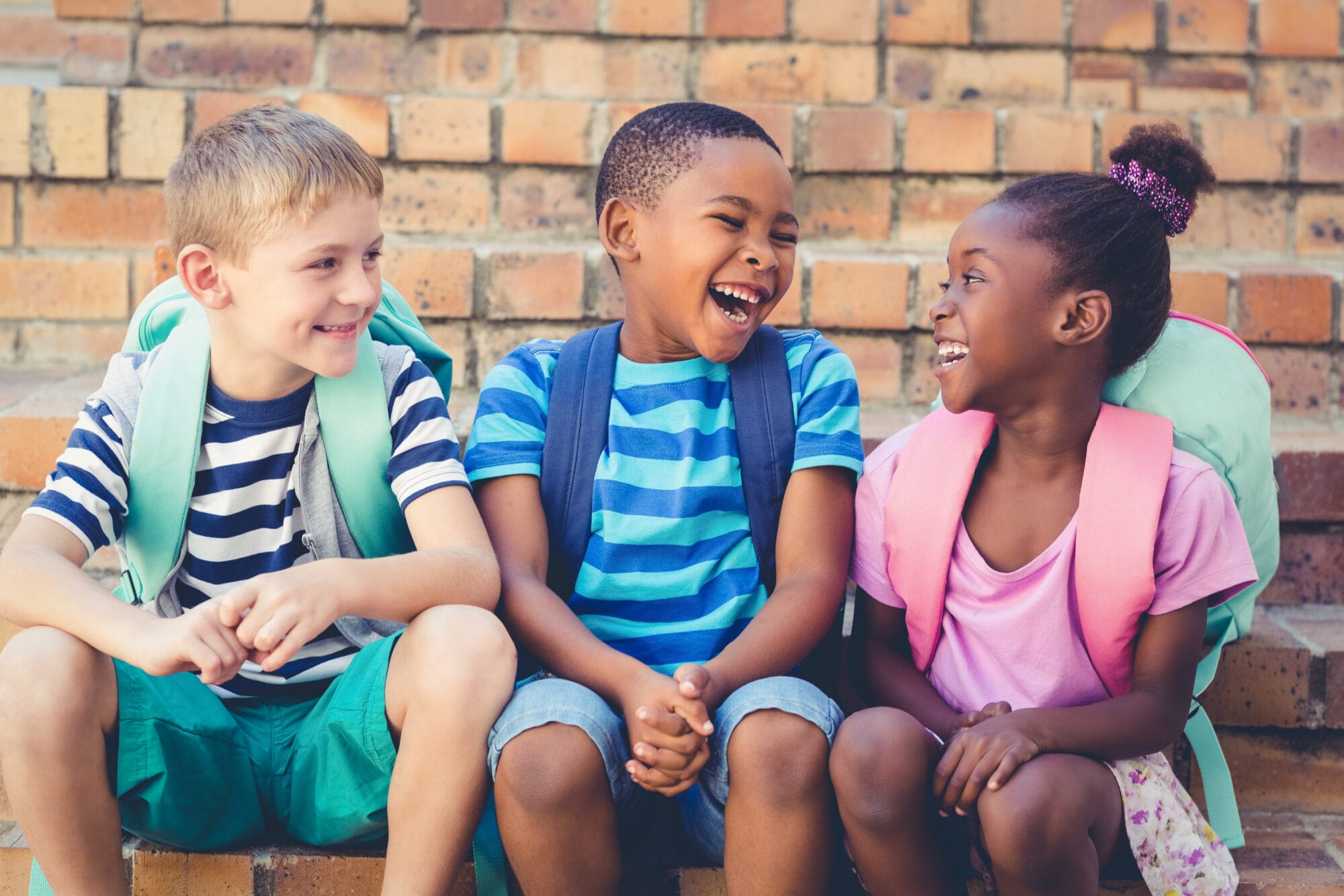 Happy,School,Kids,Sitting,Together,On,Staircase,At,School