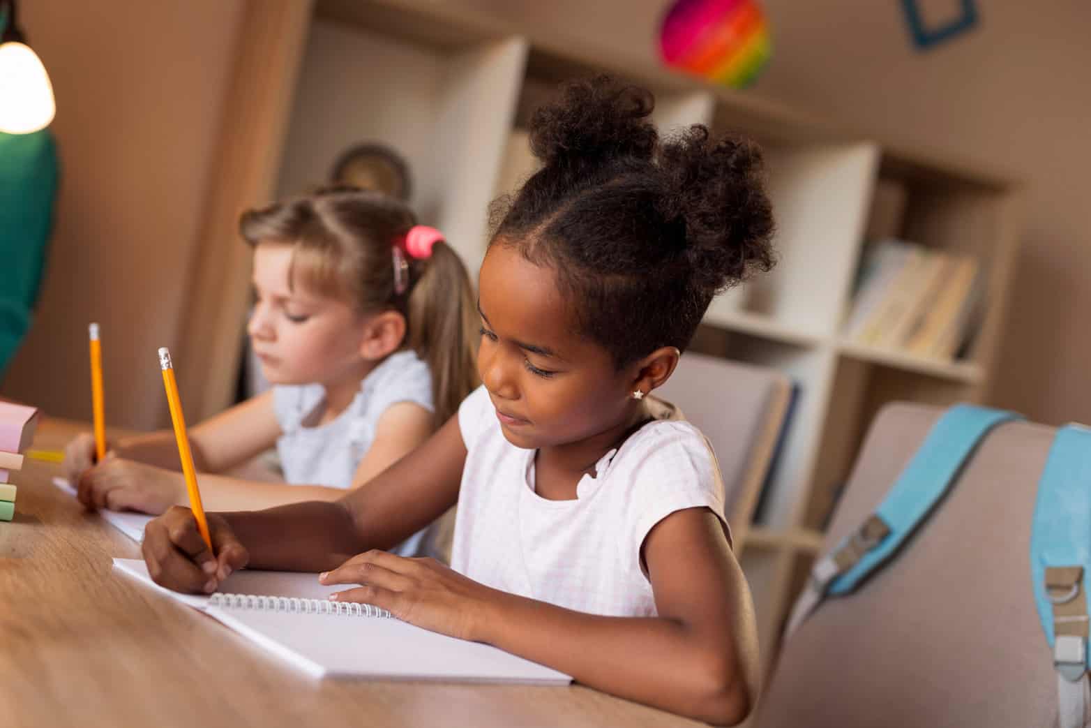 Students writing at a desk