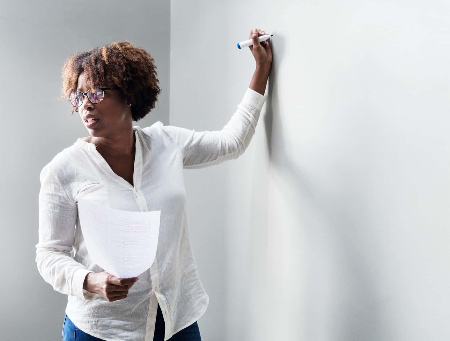 Woman writing on whiteboard