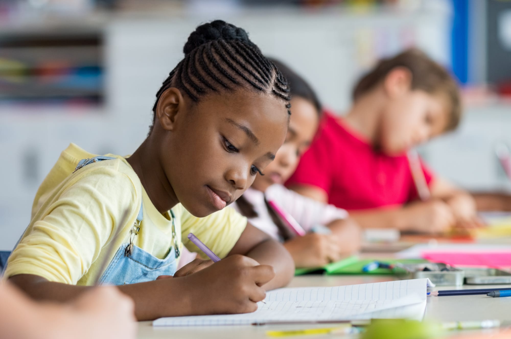 Student writing on paper