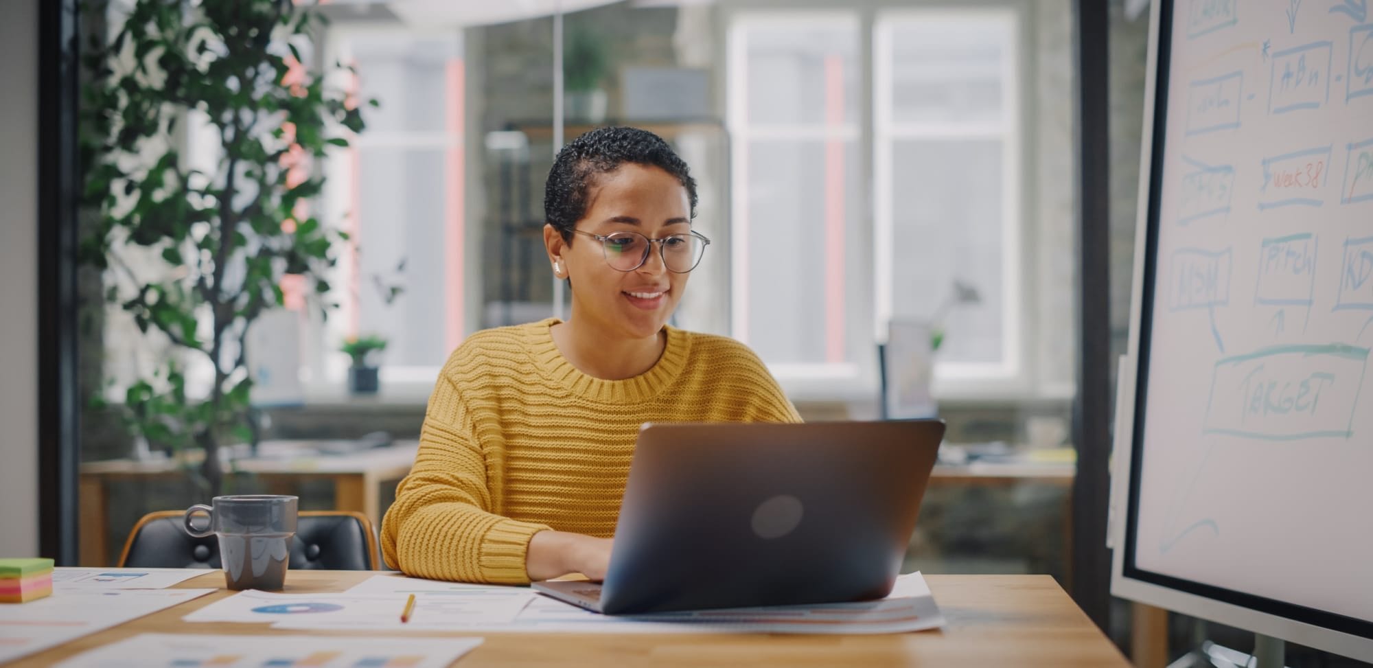 Woman writing on laptop